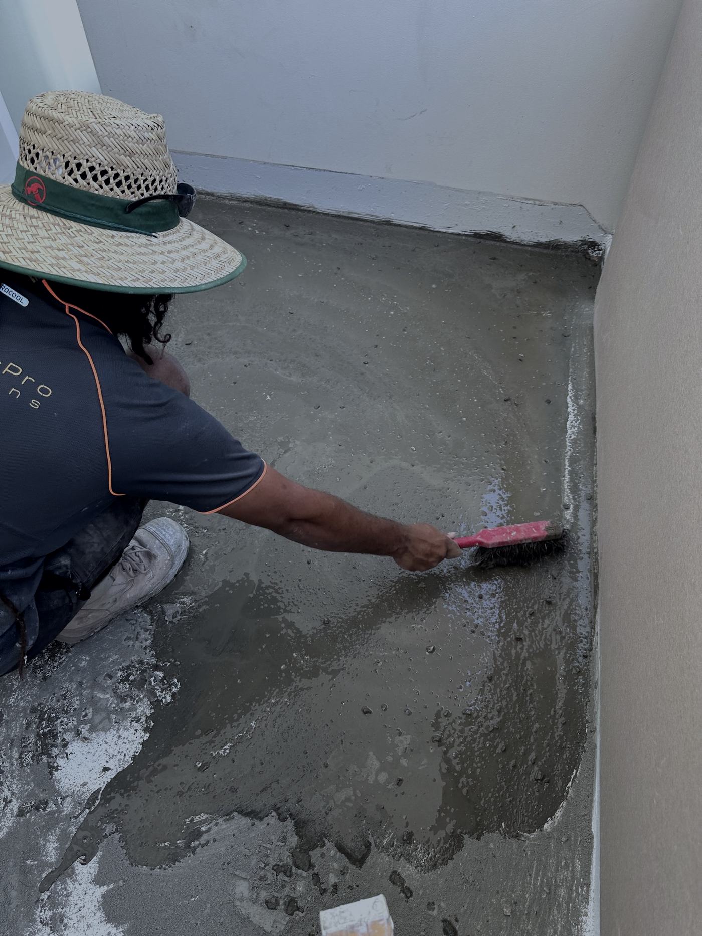 Hydro-Tec tradesman screeding a balcony floor to falls