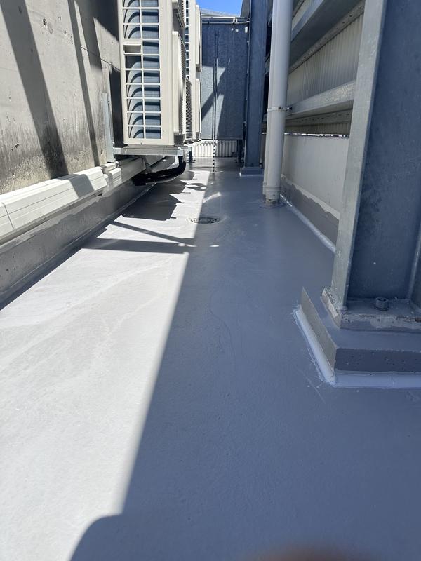 Waterproofed walkway beside a commercial building